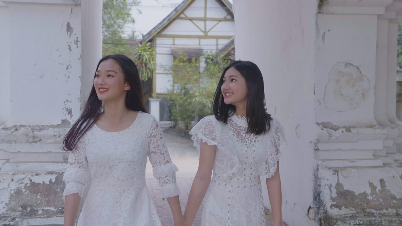 Two Asian Girls Holding Hand Smiling And Walking, Slow Motion