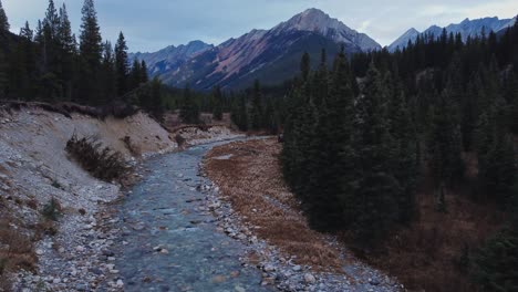 Creek-and-mountain-with-pine-tree-forest-approaching