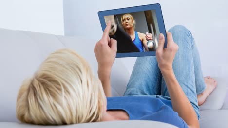 digital animation of woman watching a video of herself exercising in the digital tablet 4k