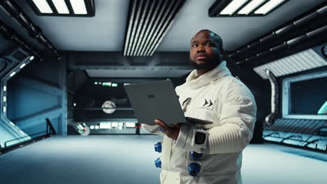 vertical video astronaut in spacecraft using laptop to run telemetry data analysis