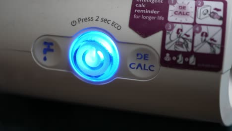 pressing the on and off button of the steam iron