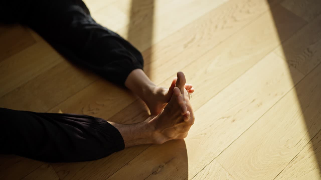 Yoga Stretching on Wooden Floor