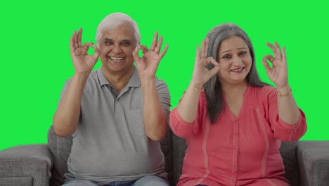 Happy-Indian-old-couple-showing-okay-sign-Green-screen