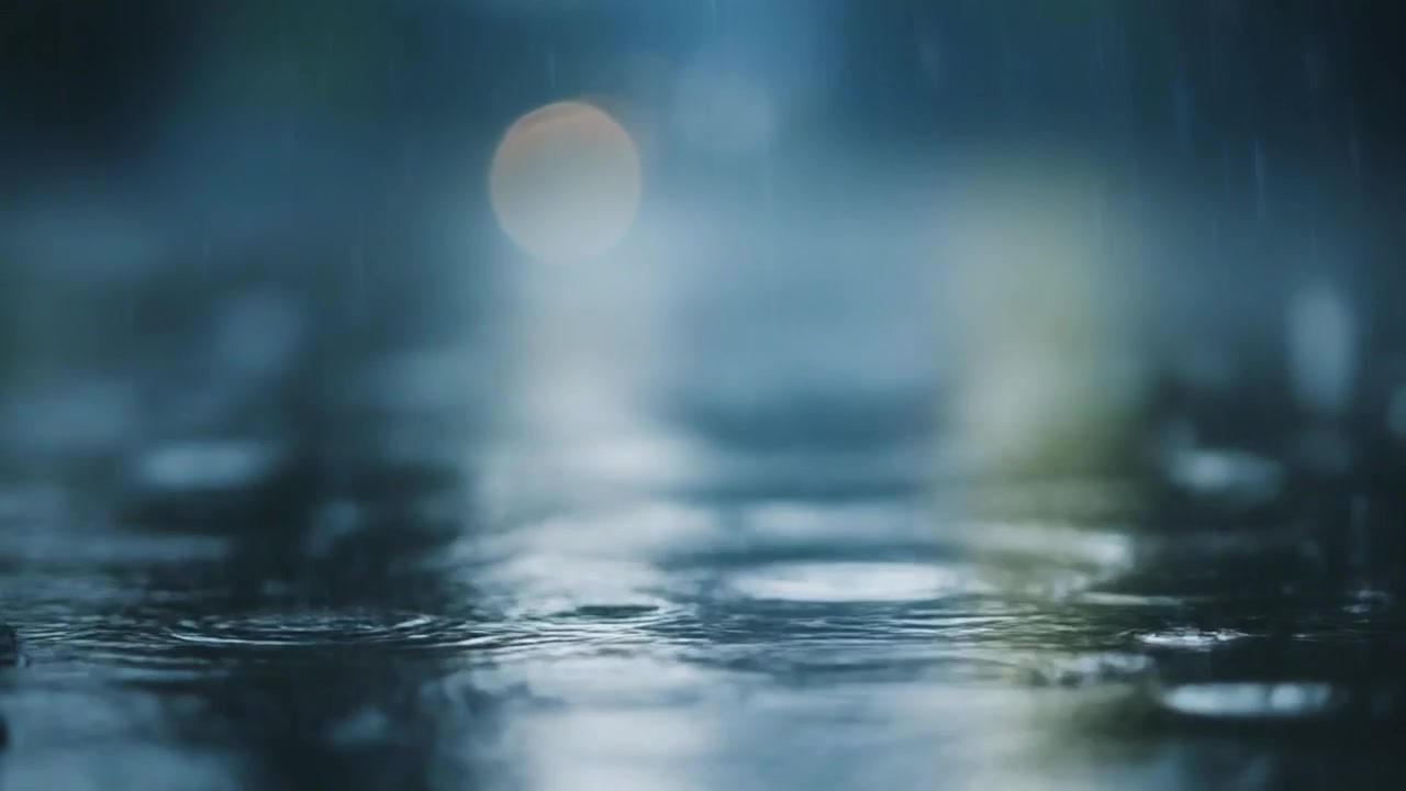 Raindrops Falling Into Puddles on Asphalt Street at Night