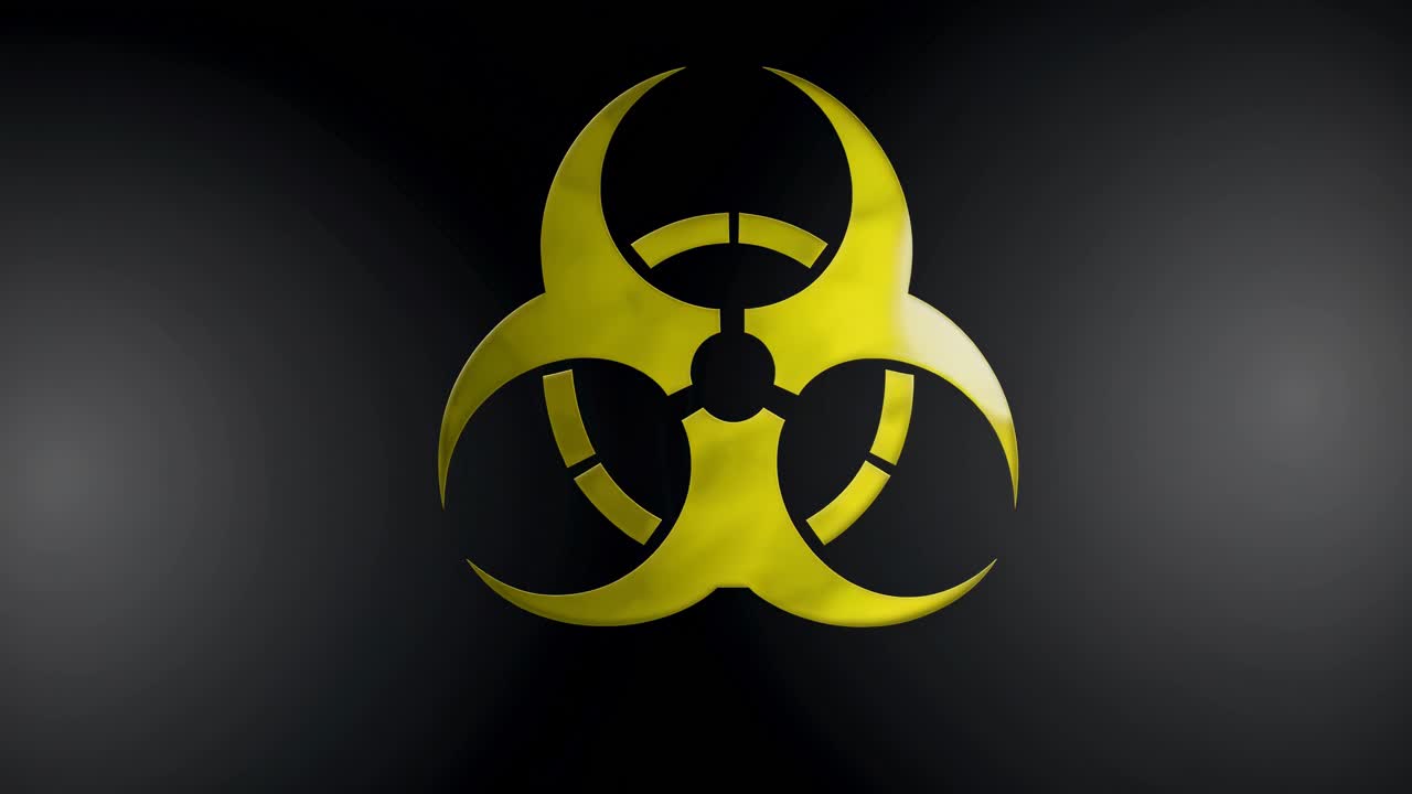Close-up of a yellow biohazard symbol on a dark background, captured from a straight-on angle