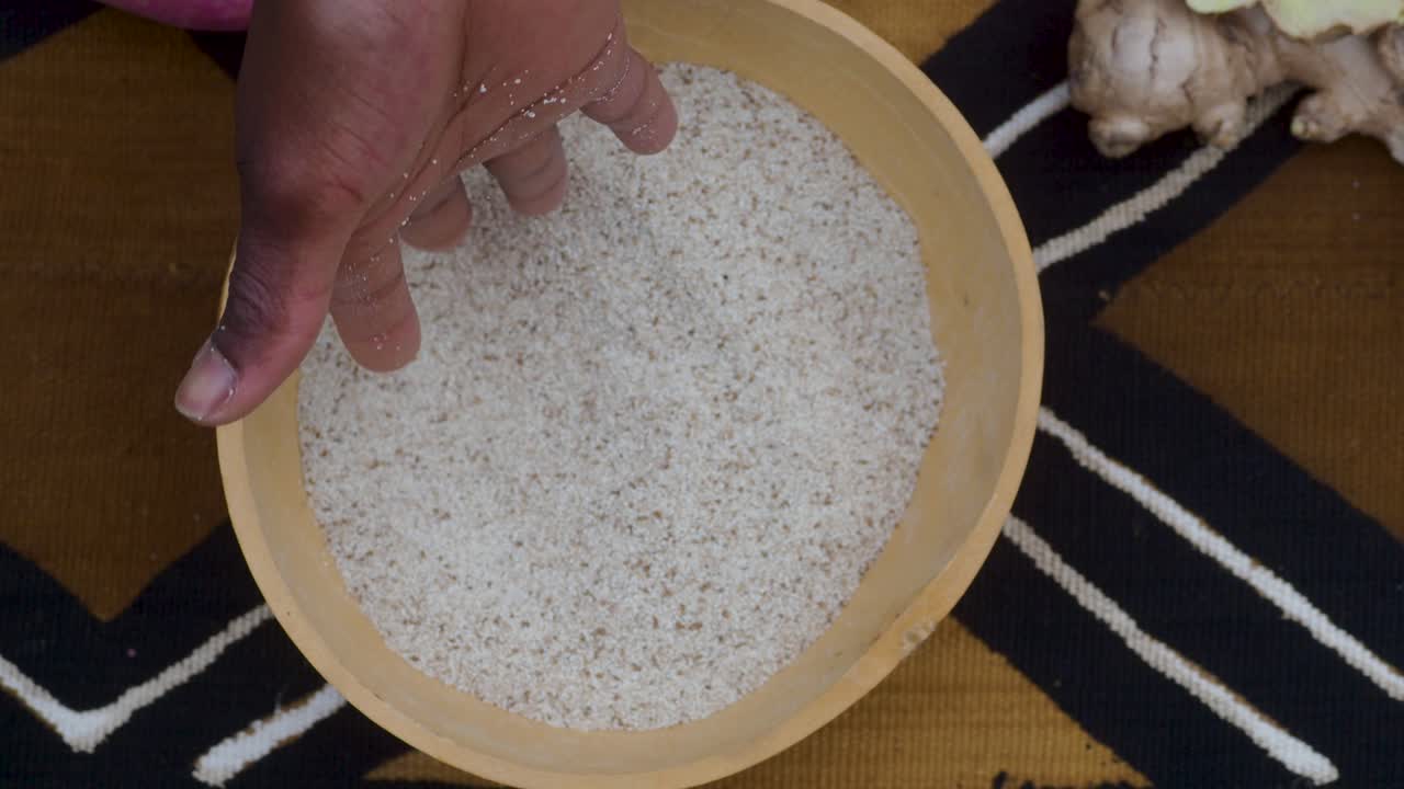 Teff grain from Africa, alternative gluten-free flour for baking and cooking. over a tipical african pattern and veggies.