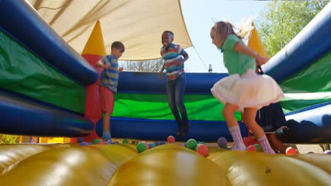 kids playing on the bouncing castle 4k