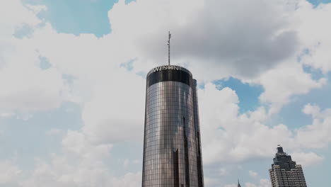 aerial ascending footage of futuristic round tower with mirroring surface