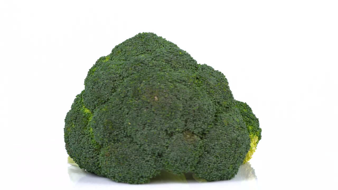 Endless Loop Of a Fresh Broccoli Rotating On a White Background. Side View.