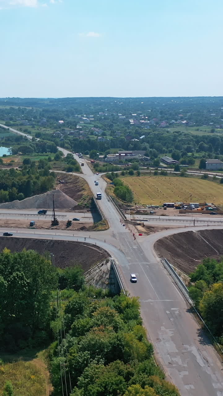 Aerial view interchange of highway. Expressway transport traffic road with vehicle movement Vertical video