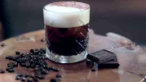 slow motion panning shot of an espresso martini with raw ingredients infront