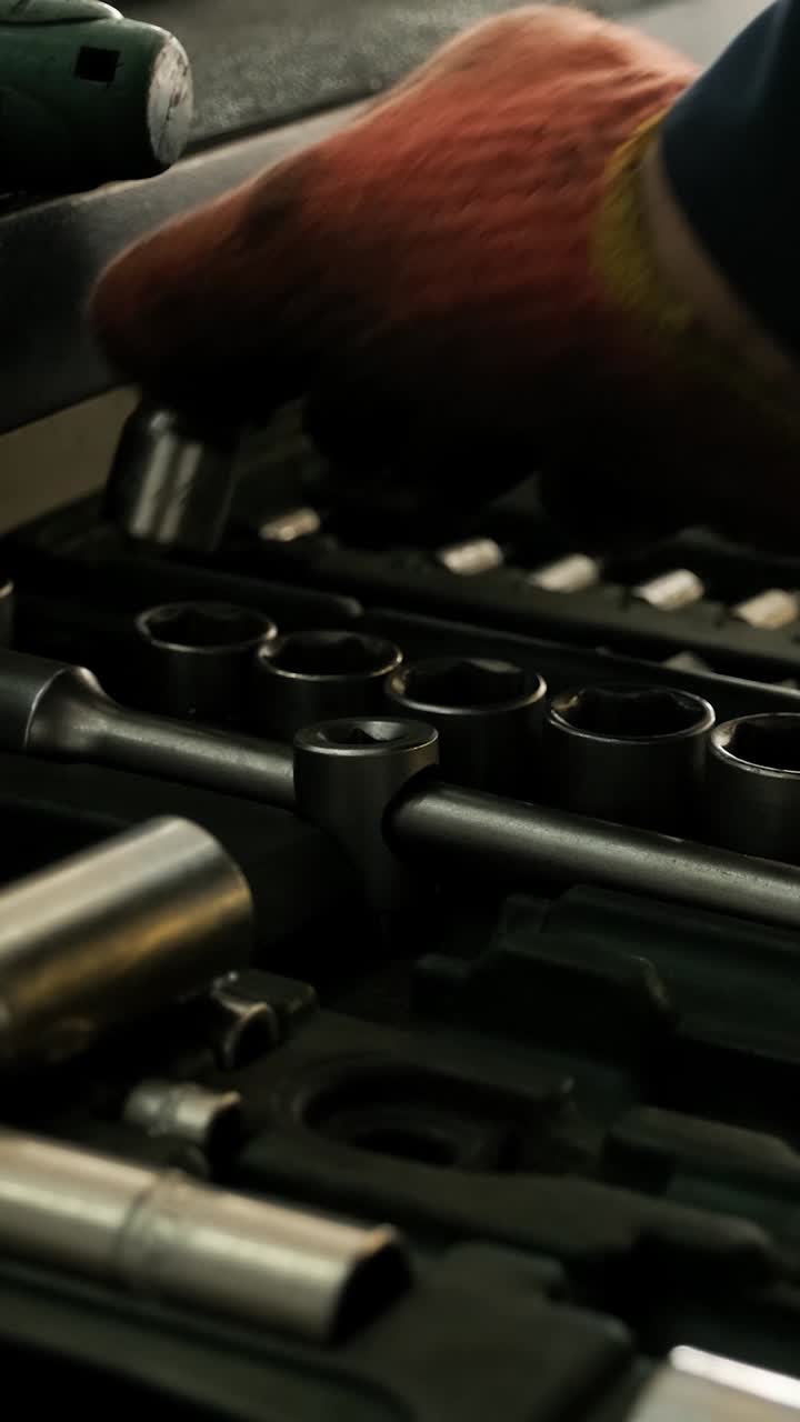 Close-Up of Hand Selecting Socket from a Toolbox