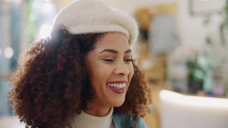 portrait of a smiling woman with curly hair and beret