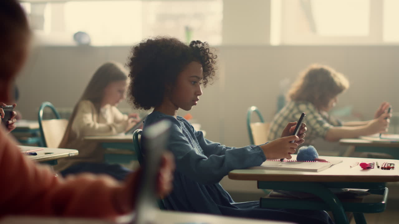 Schoolgirl doing test inline on digital tablet. Girl using tablet computer