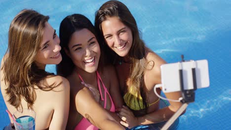 three happy young women taking their selfie