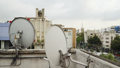 satellite dishes antennas on rooftop of old apartment building in mexico city, mexico