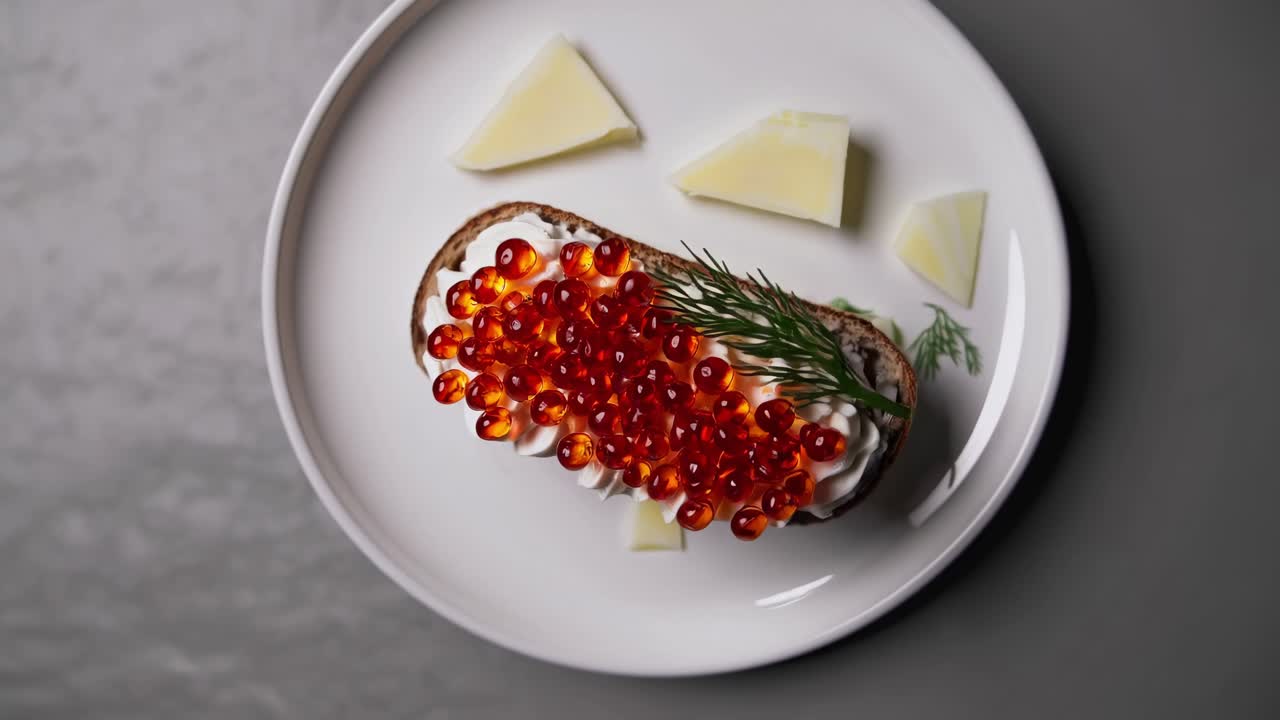 Delicious open-faced sandwich topped with vibrant salmon roe, creamy spread, and fresh herbs, showcasing culinary artistry and appetizing presentation