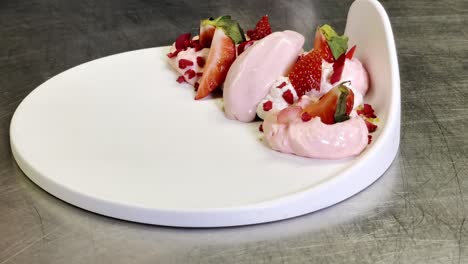 last touch of an incredible healthy dessert composed of strawberries and ice cream close up