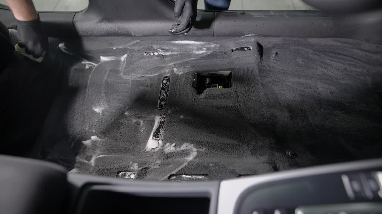 Faceless employee cleaning car interior