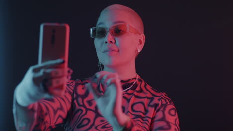 trendy woman taking a selfie in neon lighting