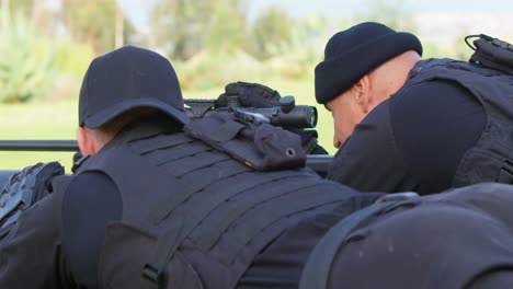 Rear-view-of-caucasian-military-soldiers-looking-through-binoculars-and-riflescope-at-training-4k