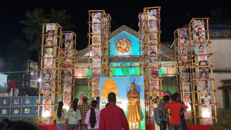 nighttime display of portraits and statue at cultural event