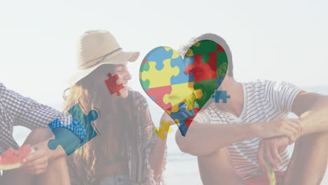 animation of colourful puzzle pieces heart over happy friends at summer beach party