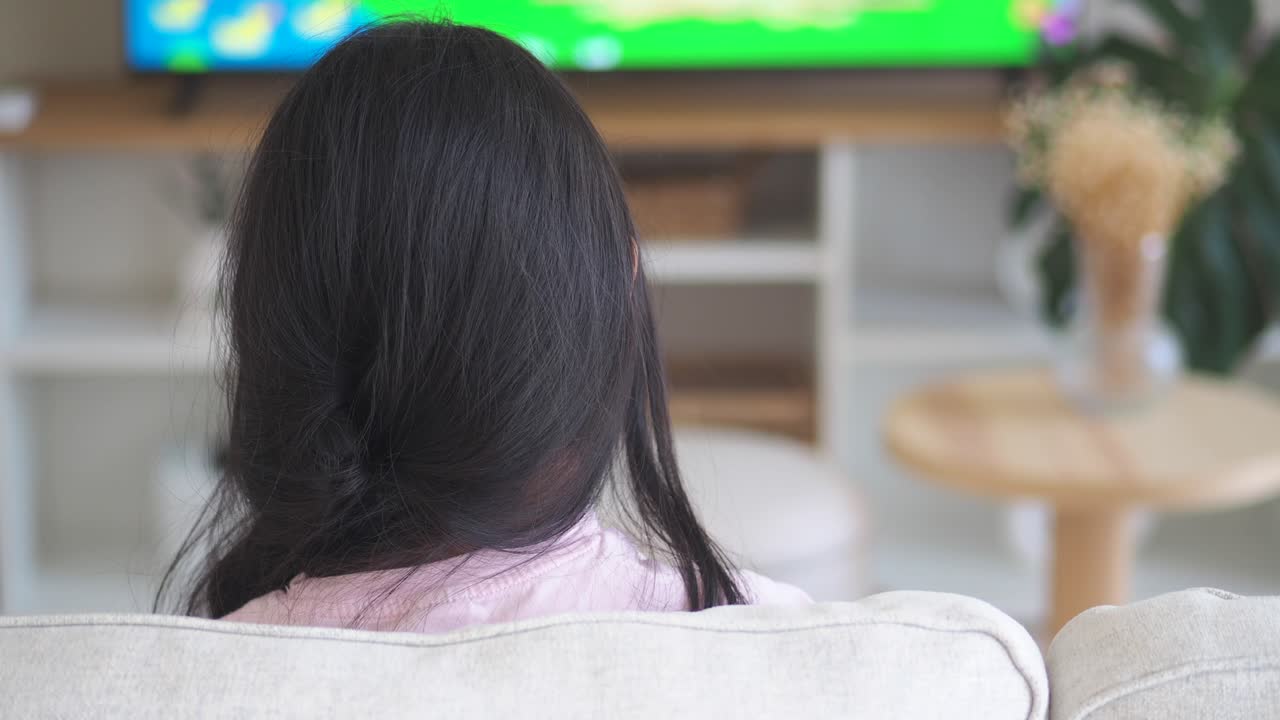 Girl watching TV at home