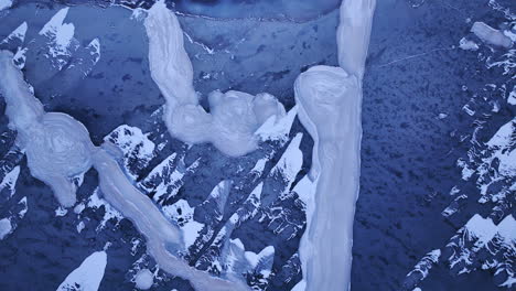 stunning footage as a drone glides over immense ice formations in the water on a cold winter day