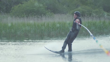 young man performs slalom skiing cut in slow motion freeskiing