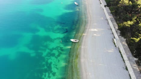 A-drone-shot-of-a-beach-in-Primosten,-Croatia