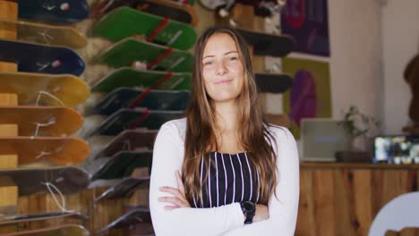 video of happy caucasian female seller in skate shop