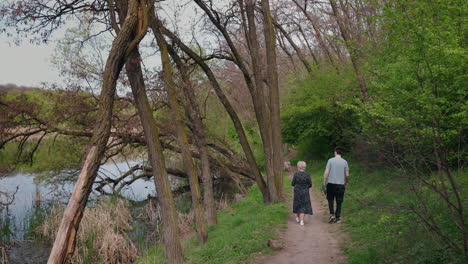 couple walking through a spring forest