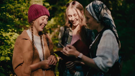 female friends sharing book during vacation