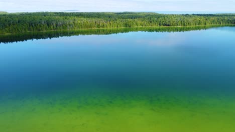 aerial dolly in shot beautiful smooth green waters of a lake huron bruce peninsula, georgian bay