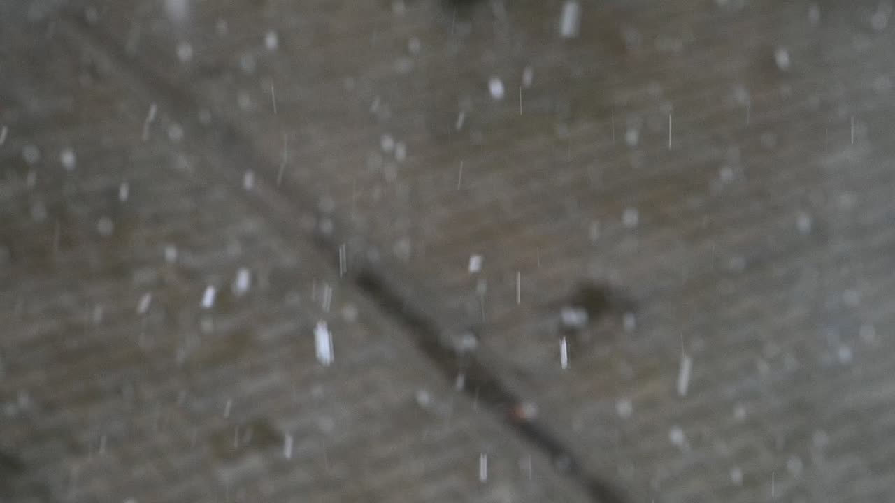 Slow motion of snow in spring. Blurred background