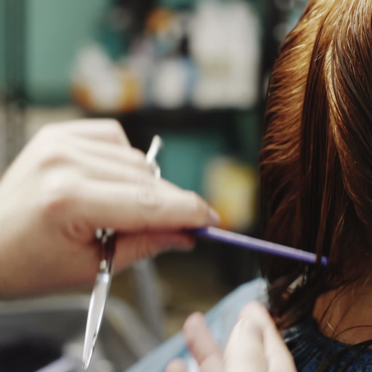 Stylish male hairdresser cuts the hair of a beautiful woman in a beauty salon. Beauty industry concept Square video