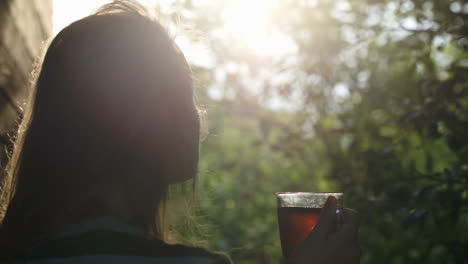 Mujer-Tomando-Té-Al-Aire-Libre-Durante-La-Puesta-De-Sol