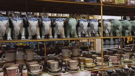 various ceramic items displayed on antique shop shelves