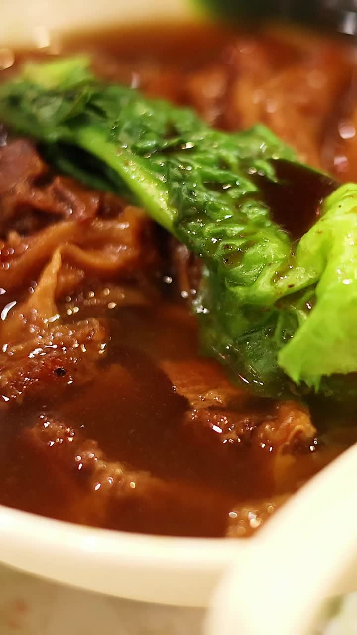 Delicious noodle bowl with meat and greens