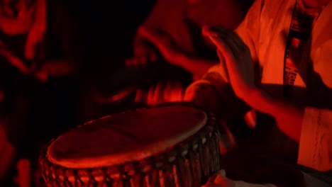 a group of people playing drums in the sahara desert, morocco, africa