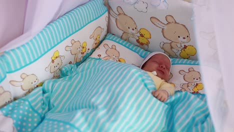 little baby in white bodysuit peacefully sleeping on parents hand little baby in white bodysuit peacefully sleeping on parents hand fathers finger is touching tiny kids nose close up