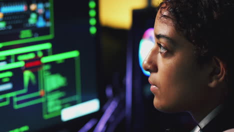 female teenage hacker sitting in front of computer screens bypassing cyber security