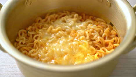 korean spicy instant noodle bowl with mozzarella cheese