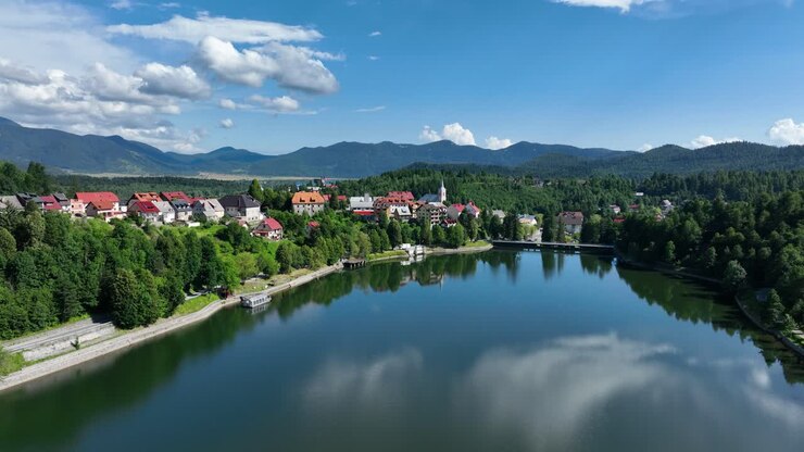 Vista aerea di un pittoresco villaggio di montagna adagiato vicino a un lago sereno