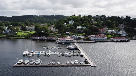 Ljungskile-boat-and-sailing-club-in-Bohuslan-Sweden-on-sunny-day-at-piers,-Aerial-Orbit