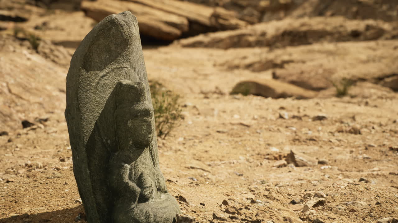 Ancient stone carving discovered in an arid landscape during daylight hours