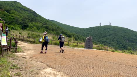 slow motion shot of hiker couple with backpack climbing on south korean mountains in jirisan national park during sunny day