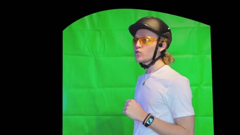 Sports-person-explaining-headphones-in-helmet---greenscreen