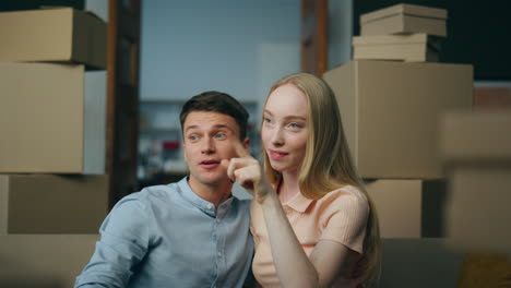 Homeowners-discussing-interior-design-sitting-on-new-house-near-boxes-close-up.